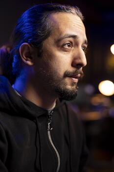 Close up of hacker in secret hideout bypassing firewalls, launching DDoS attacks on websites. Rogue engineer at home working on malware scripts that can crash businesses servers photo