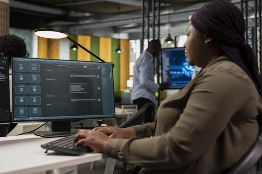 System administrator in office using large language model application to get help with coding tasks. Computer scientist at work interacting with AI LLM chatbot GPT software on PC photo