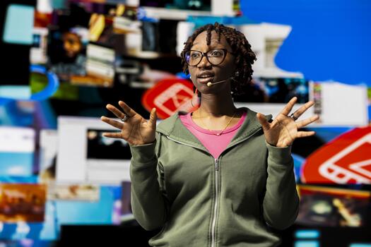 Influencer doing key note presentation in front of audience using visualizations on digital interface. Digital creator using mic to speak about content creation and social network experiences photo