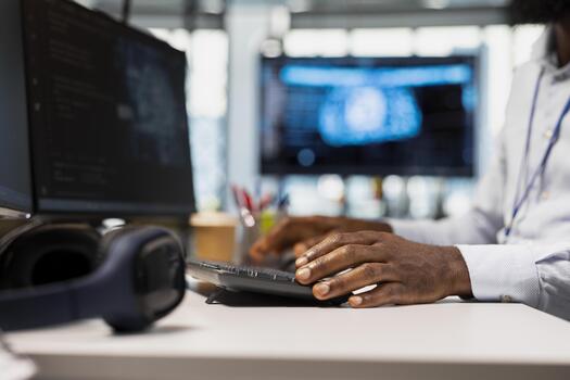 cerca arriba de técnico en oficina mecanografía en teclado, corriendo ai automatización guiones a reducir repetitivo codificación tareas. trabajador escritura código, utilizando artificial inteligencia tecnología en ordenador personal foto