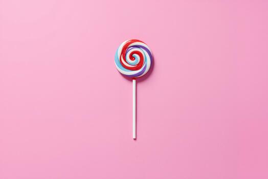 a colorful lollipop on a pink background photo