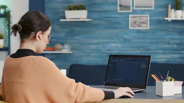 Female coder programming analytics report on technical interface, using hacking software to create binary code information and data. Programmer using virtual system and network on laptop. photo