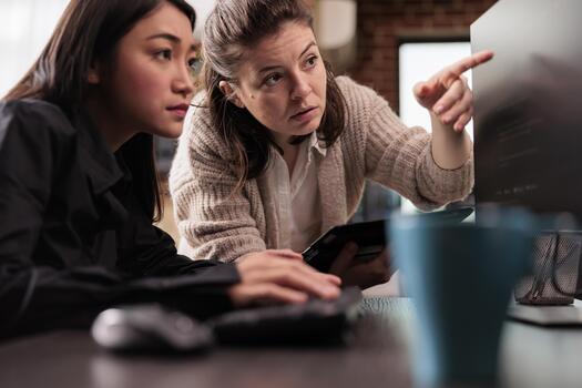 System engineers collaborating on coding project, discussing about programming algorithm for new cloud computing user interface. Diverse team of software developers running database system code. photo