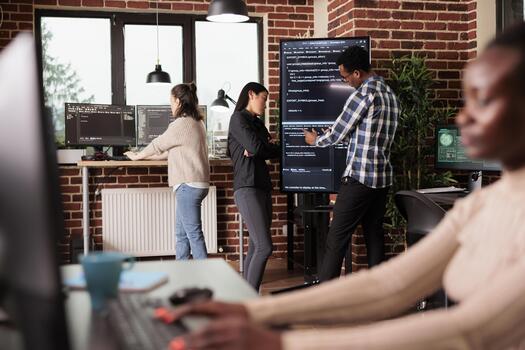 Tech enginners using binary code to script security system, programming firewall encryption. Diverse team working with program data server to develop network on coding software. Programmer concept photo