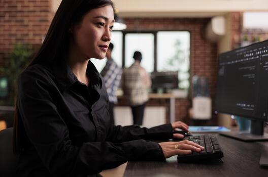 Software developer writing javascript code on terminal window, working with computer displaying coding algorithm, asian tech engineer programming big data in company office. photo