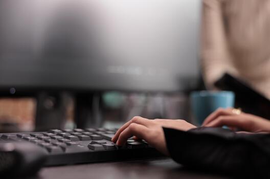 App developer types machine learning code on a computer while checking an artificial intelligence project and database script in a software office. photo
