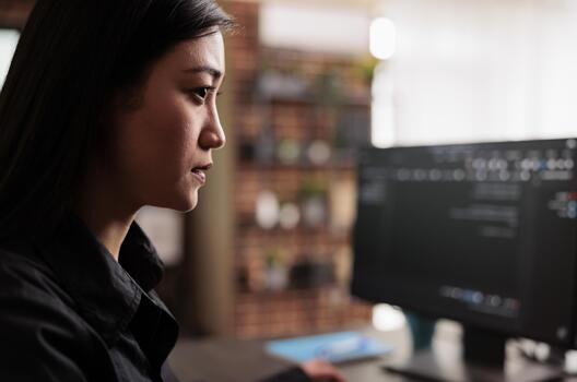 System engineer writes JavaScript terminal code on a terminal window while programming HTML, JavaScript and data algorithms for cloud computing inside a company office. photo