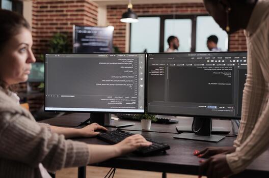 Diverse programming engineers developing html code and cloud computing in it development agency, Software developer working on database programming with html script, computing big data. photo