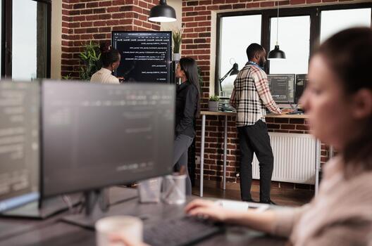 Developers analyze machine learning application code, combining programming code, software teamwork and digital infrastructure inside a technology office. photo