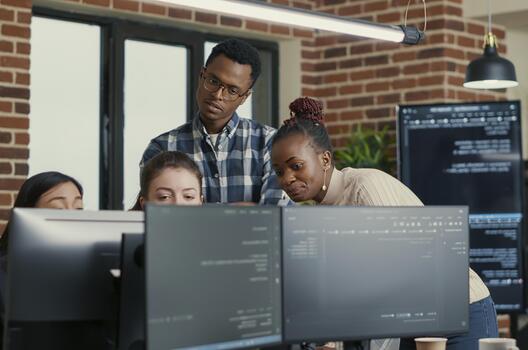 Developers Brainstorming Code Feedback with Intern in a software development office, showing programmers collaborating on source code, algorithms and data coding workflow. photo