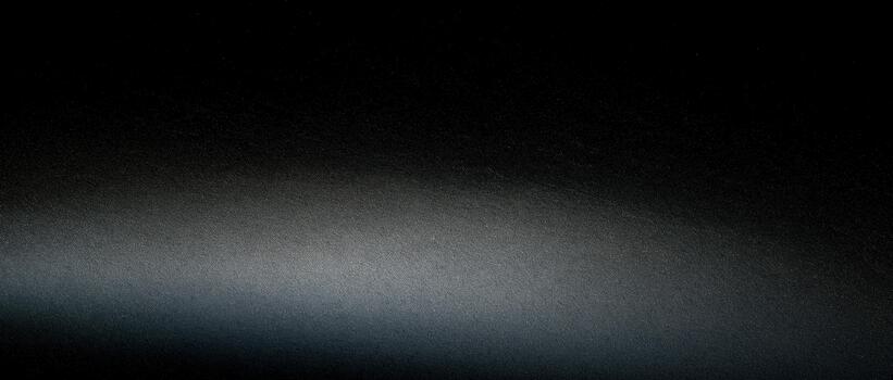 Light and shadow create a gradient effect on dark surface photo