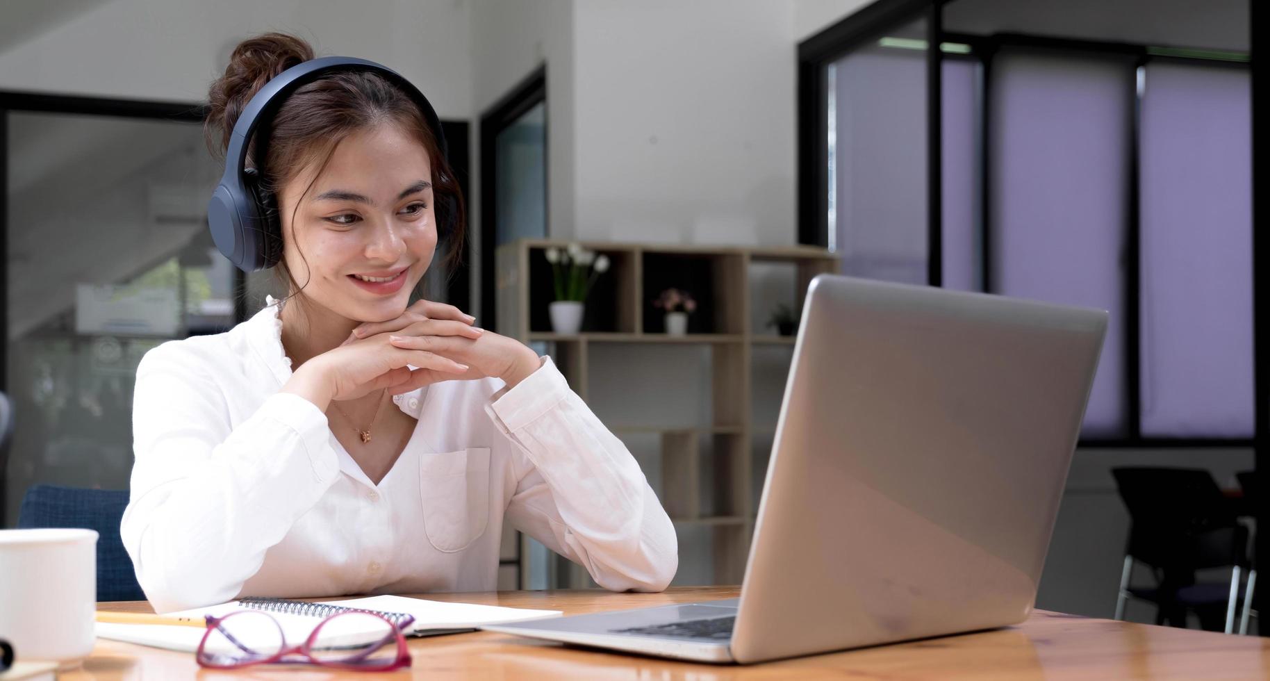 primo piano di studenti che imparano a lezione online utilizzando un computer portatile e scrivendo un notebook sul posto di lavoro, e-learning e concetto di lavoro online. foto