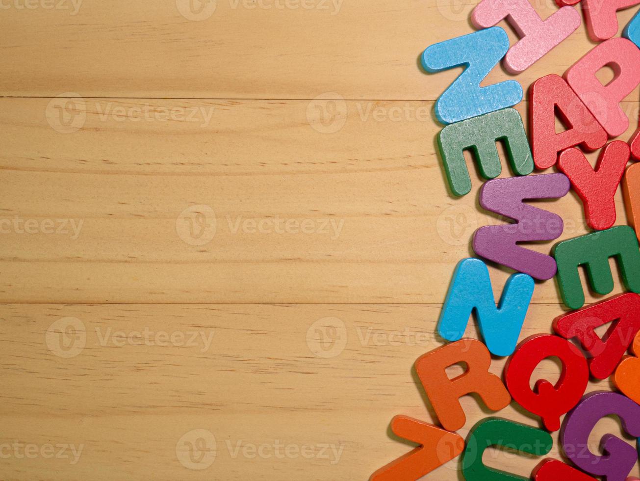 l'alfabeto multicolore sul tavolo di legno per l'istruzione o il concetto di bambino foto