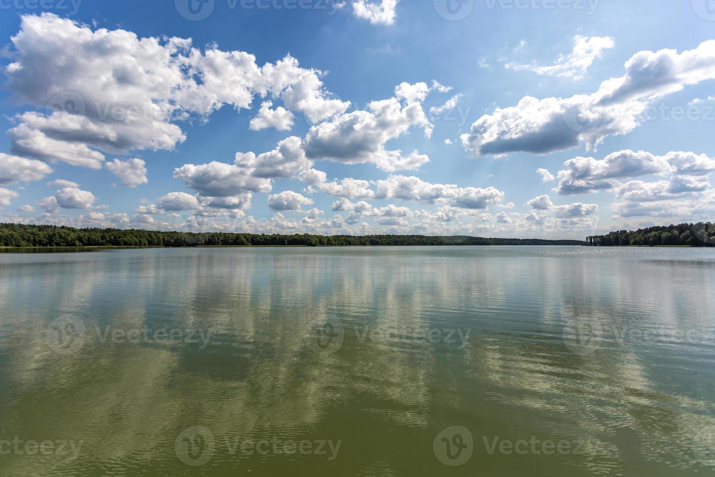 riflesso nell'acqua di un grande lago forestale foto