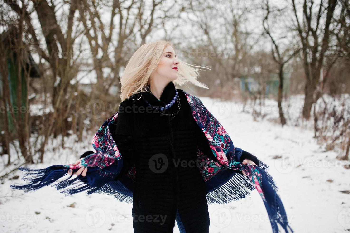 ragazza bionda con sciarpa ricamata a mano posta al giorno d'inverno. fazzoletto da donna. foto