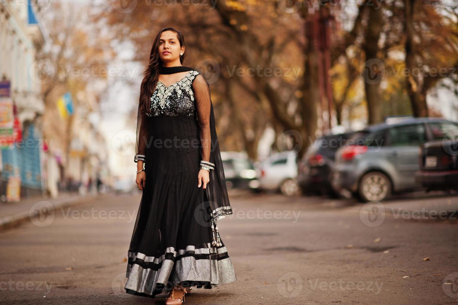 bella ragazza indiana in abito saree nero poste all'aperto in autunno street. foto