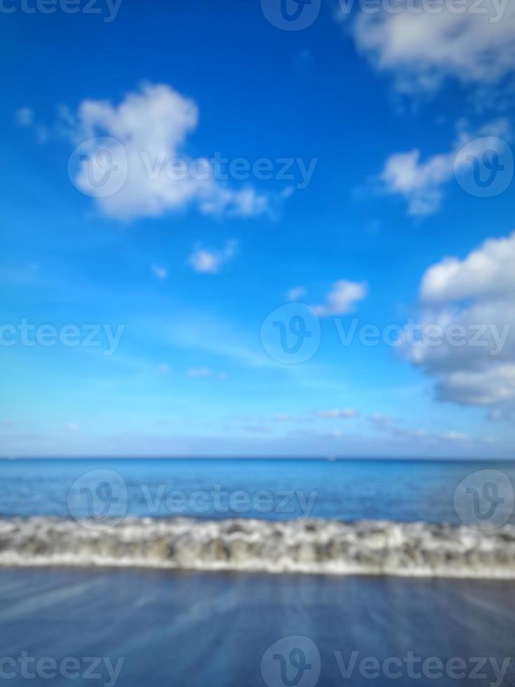 sfocatura dello sfondo astratto della spiaggia con cielo blu brillante foto