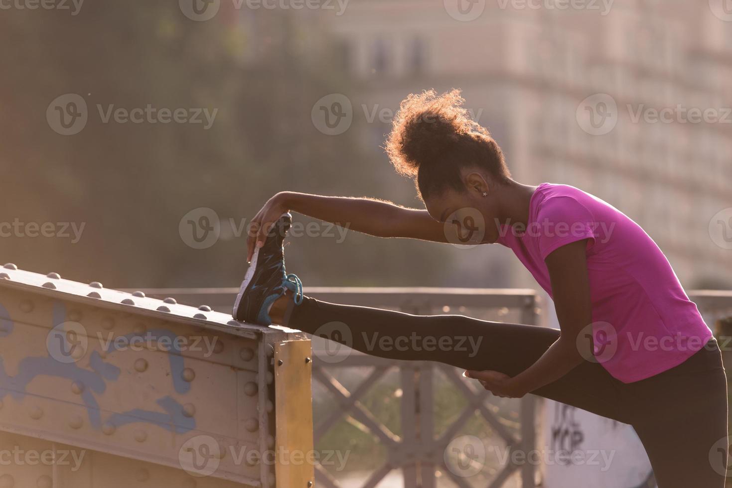 africano americano donna fare riscaldamento su e allungamento foto