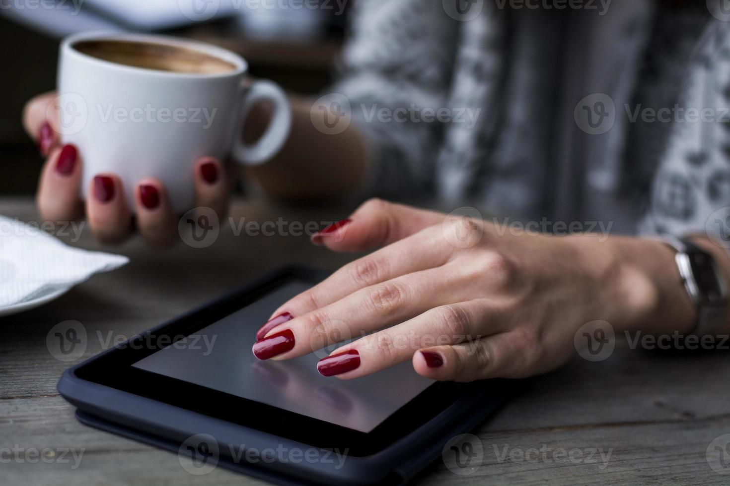 mano di donna navigando sul tablet foto