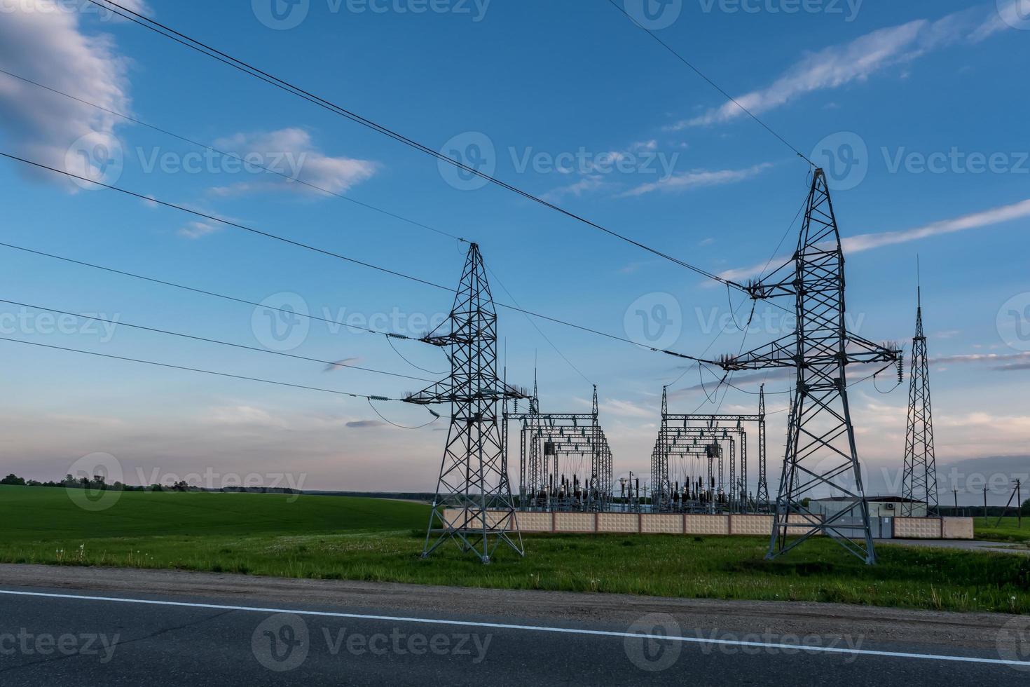 silhouette delle torri del pilone elettrico ad alta tensione sullo sfondo di belle nuvole serali foto