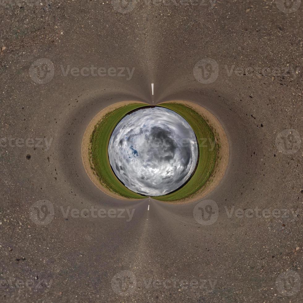 palla di cielo blu nel mezzo del campo vorticoso. inversione del minuscolo pianeta trasformazione del panorama sferico a 360 gradi. curvatura dello spazio. foto