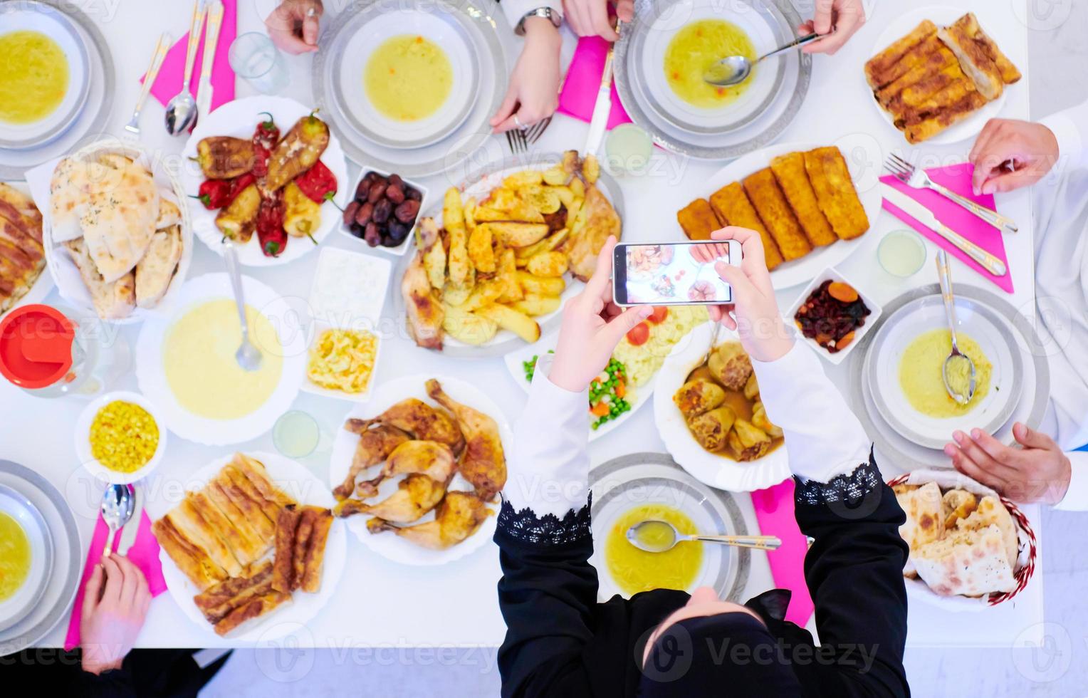 musulmano famiglia avendo iftar cena assunzione immagini con mobile Telefono foto