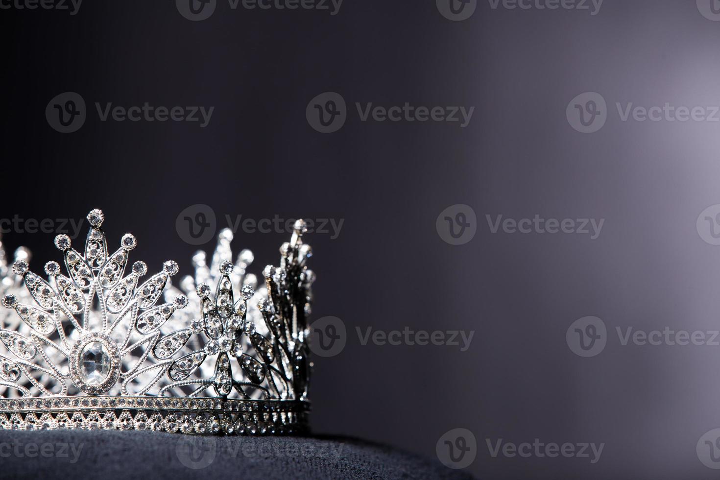 diamante argento corona per Perdere spettacolo bellezza concorso, cristallo tiara gioielleria decorato gemme pietra e astratto buio sfondo su nero velluto tessuto stoffa, macro fotografia copia spazio per testo logo foto