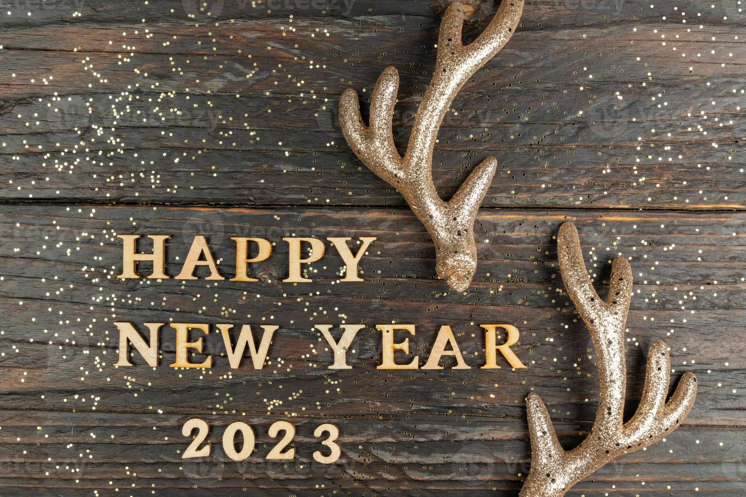 contento nuovo anno 2023. citazione fatto a partire dal di legno lettere e numeri 2023 su di legno sfondo decorato Renna corna. creativo concetto per nuovo anno saluto carta foto