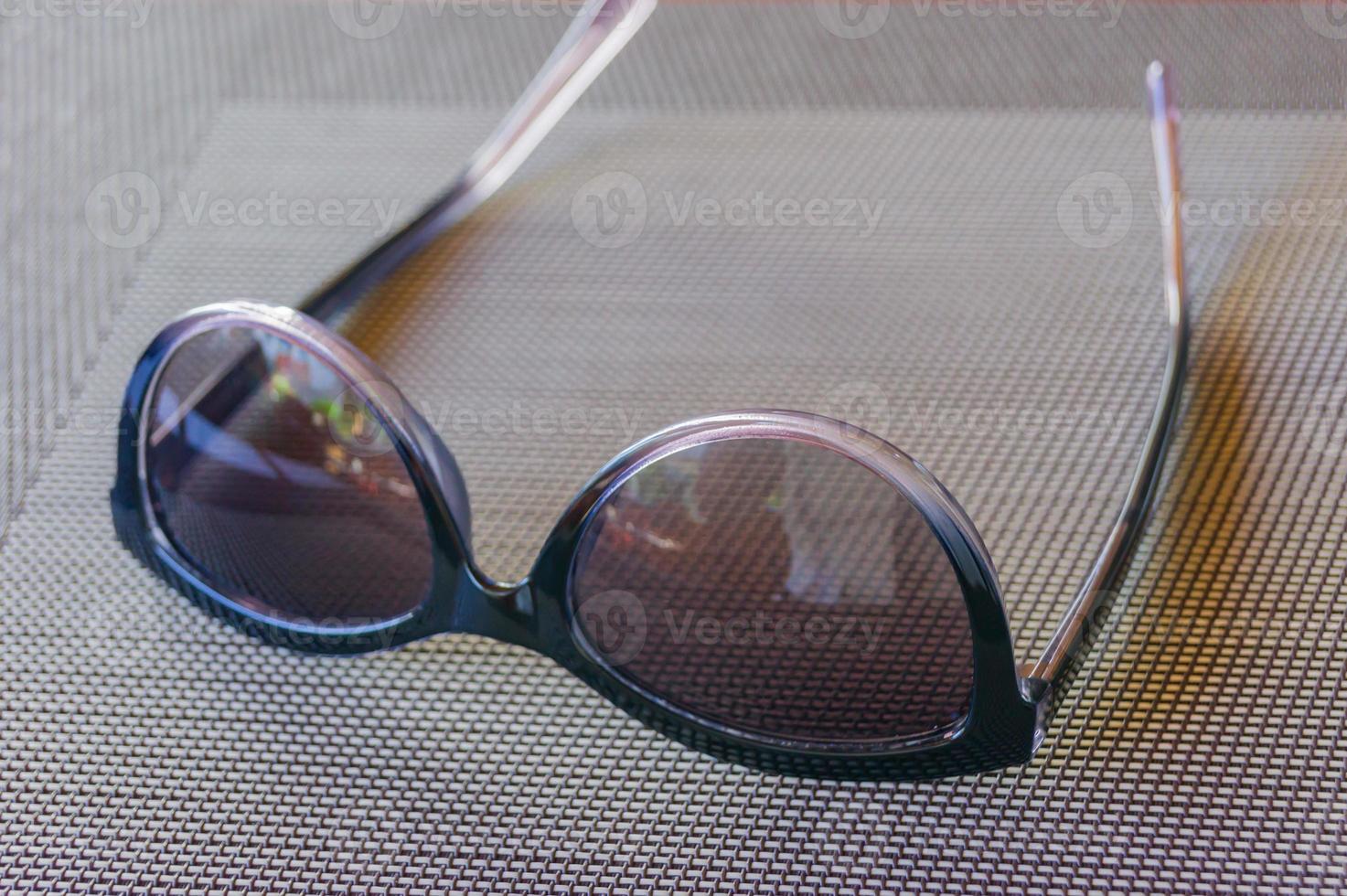 occhiali da sole alla moda su un tavolo. concetto estivo. stile di colore vintage foto