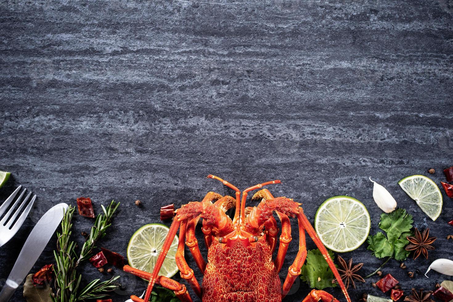 cucinato bollito aragosta, delizioso cena frutti di mare pasto impostato con coltello e forchetta su nero pietra ardesia sfondo, ristorante menù disegno, superiore Visualizza, alto foto