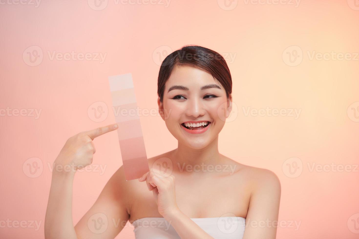 carino donna prendere pelle colore scala su il beige sfondo foto