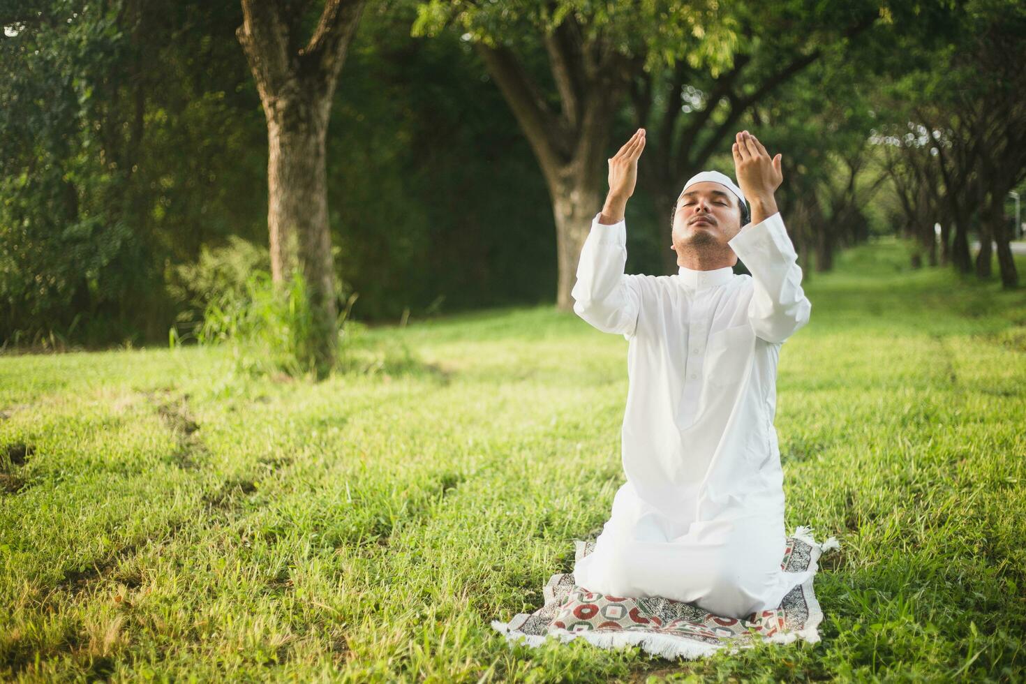 musulmano uomo preghiere all'aperto. natura paesaggio.musulmano uomo preghiere su verde prato.musulmano preghiera, il leggero di fede, speranza, fede. musulmano uomo preghiere per Allah Dio di Islam su verde prato. foto