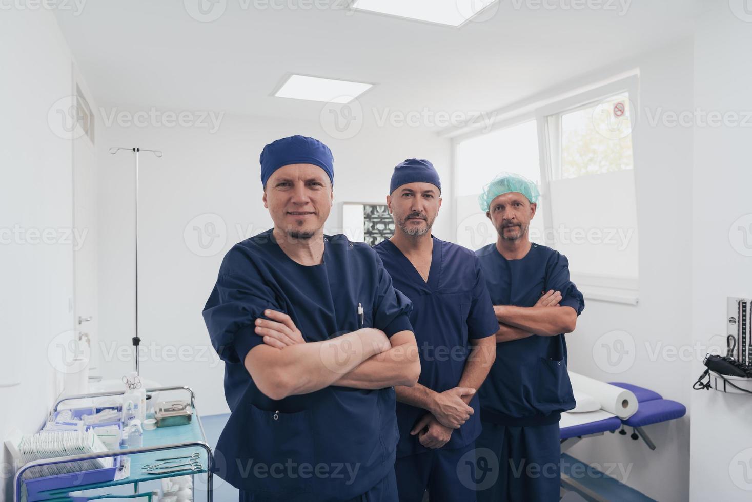 multietnico ortopedico medico nel davanti di il suo medico squadra guardare a telecamera indossare viso maschera foto