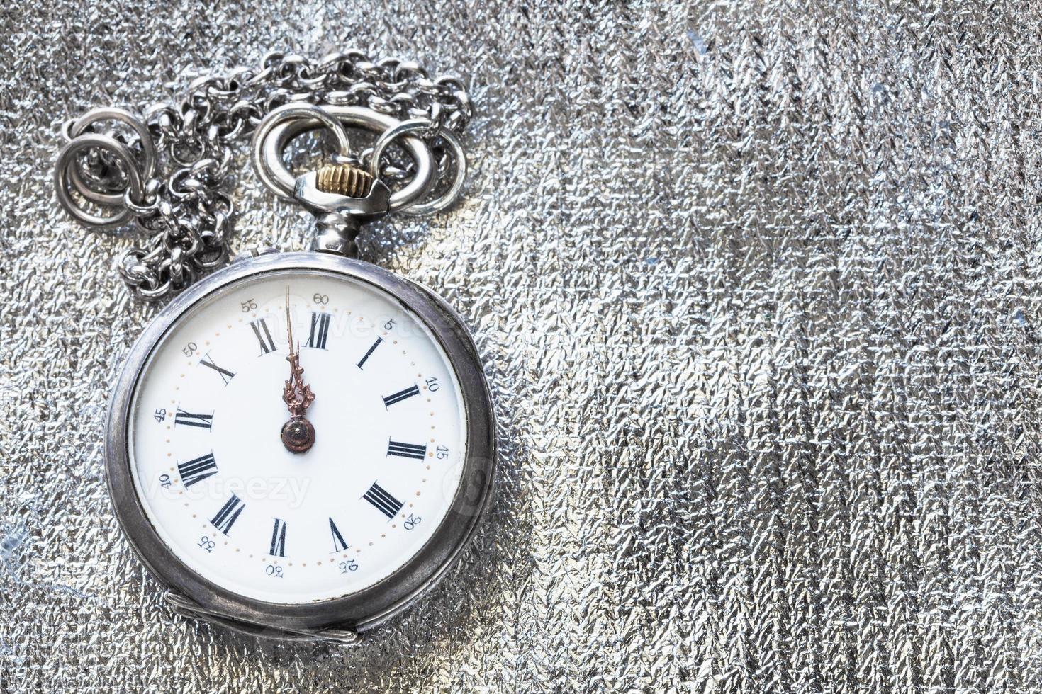 Vintage ▾ tasca orologio su argento tessile sfondo foto