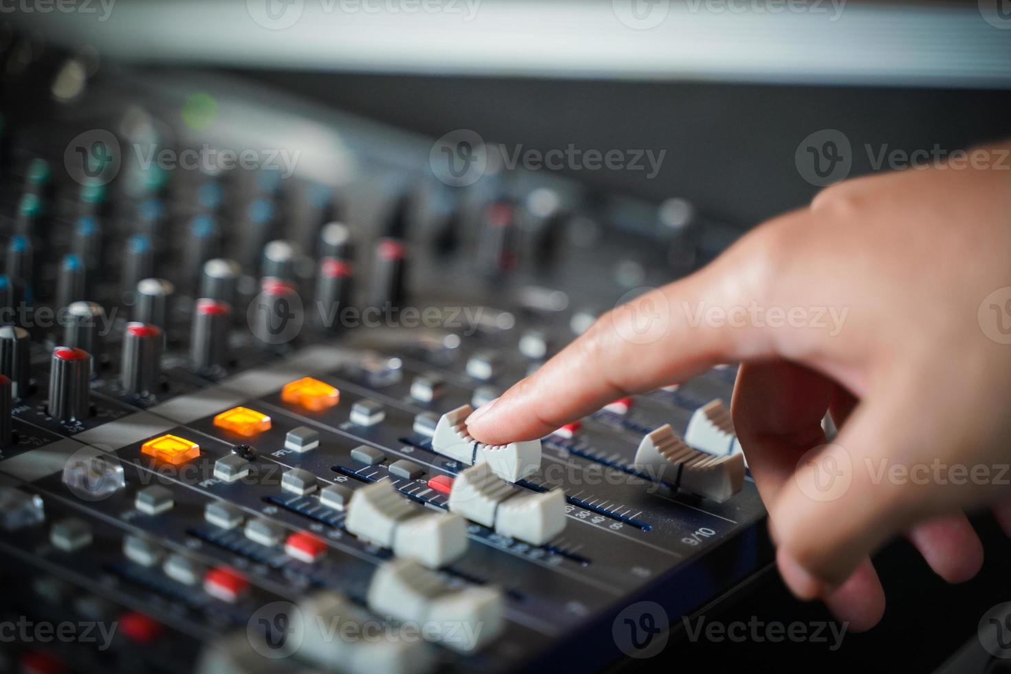 Uomini mani siamo controllo il consolle di un' grande hi-fi sistema.con fiuto leggero foto