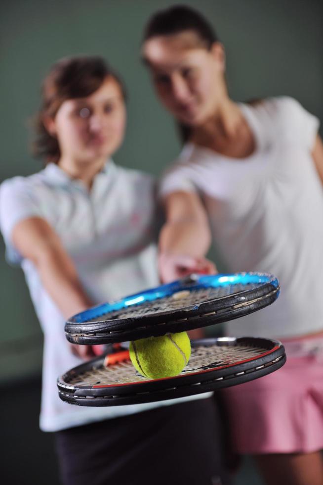 giovane ragazze giocando tennis gioco interno foto