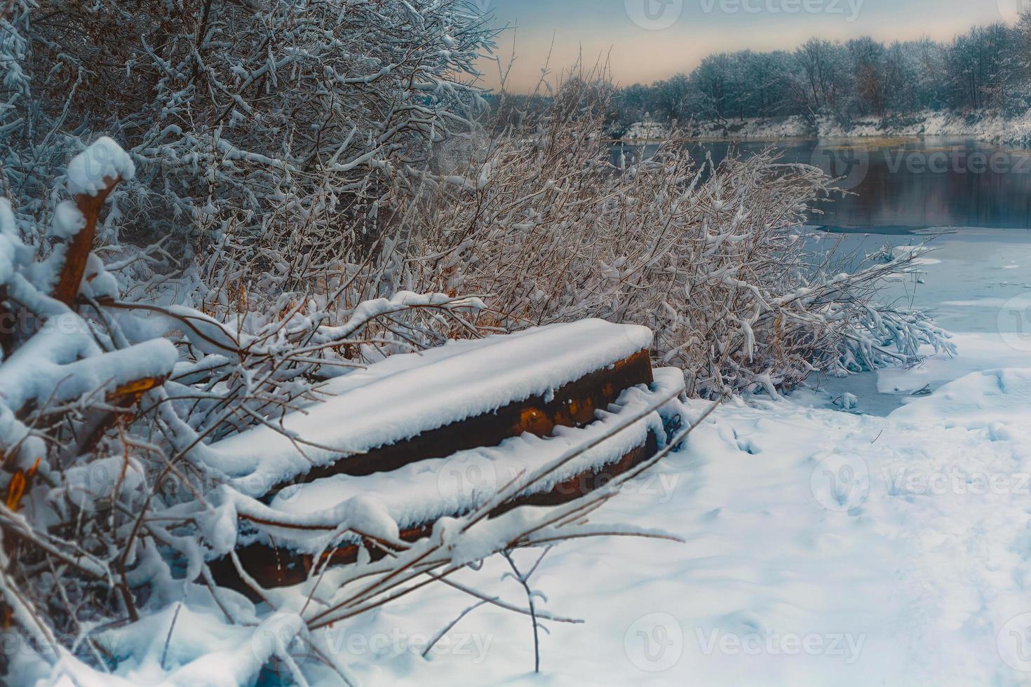 il barca bugie su il banca di il fiume nel inverno foto