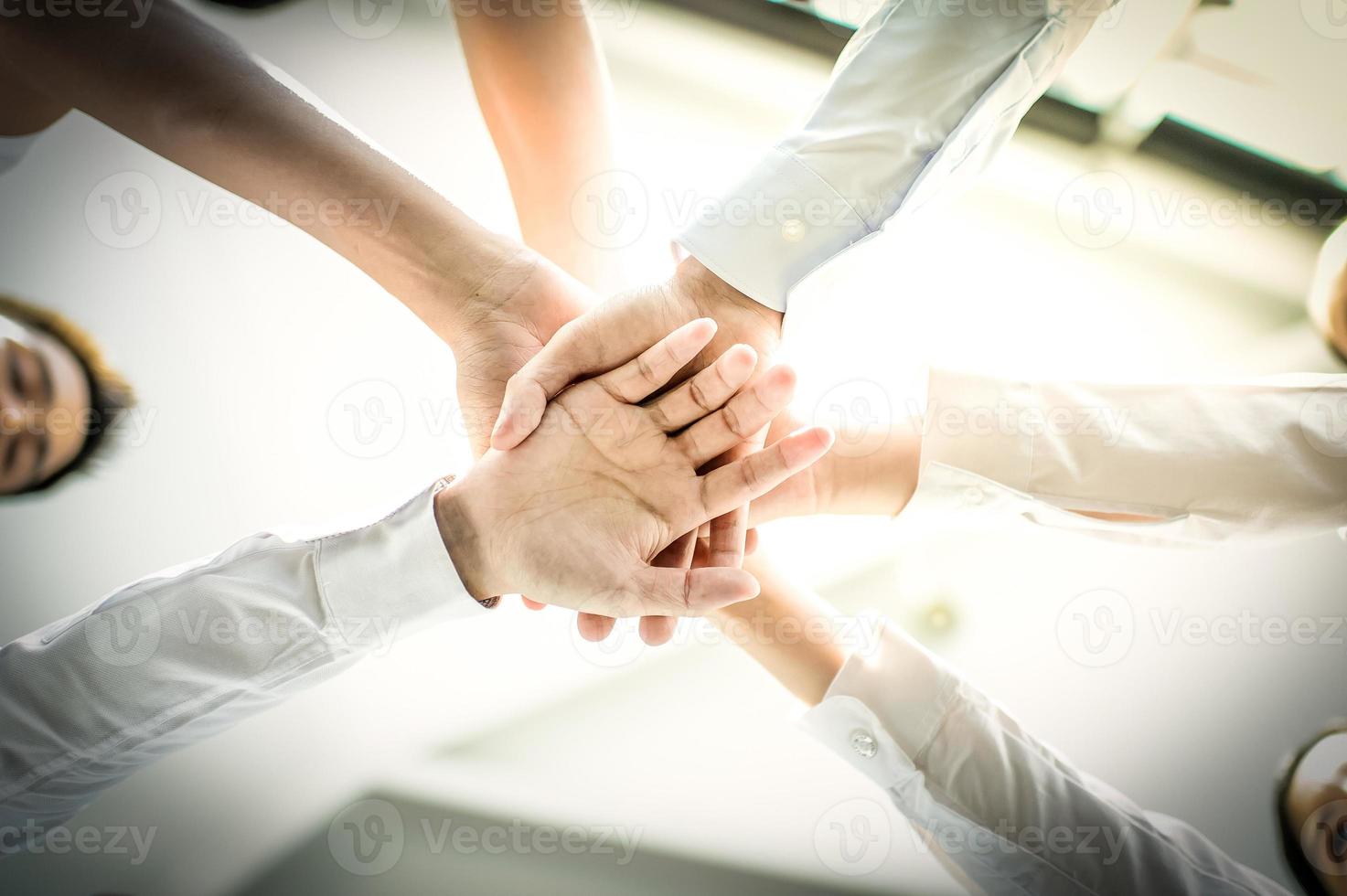 vicino su di giovane uomini d'affari mettere loro mani insieme. pila di mani concetto di unità e lavoro di squadra. foto