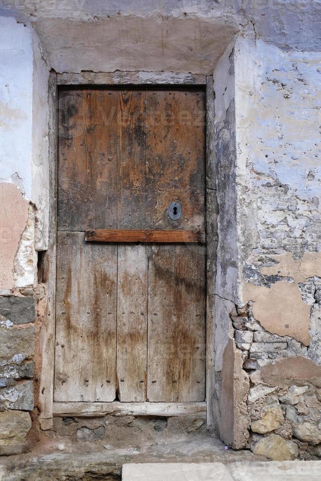 vecchio Esposto alle intemperie di legno porta nel un vecchio edificio foto