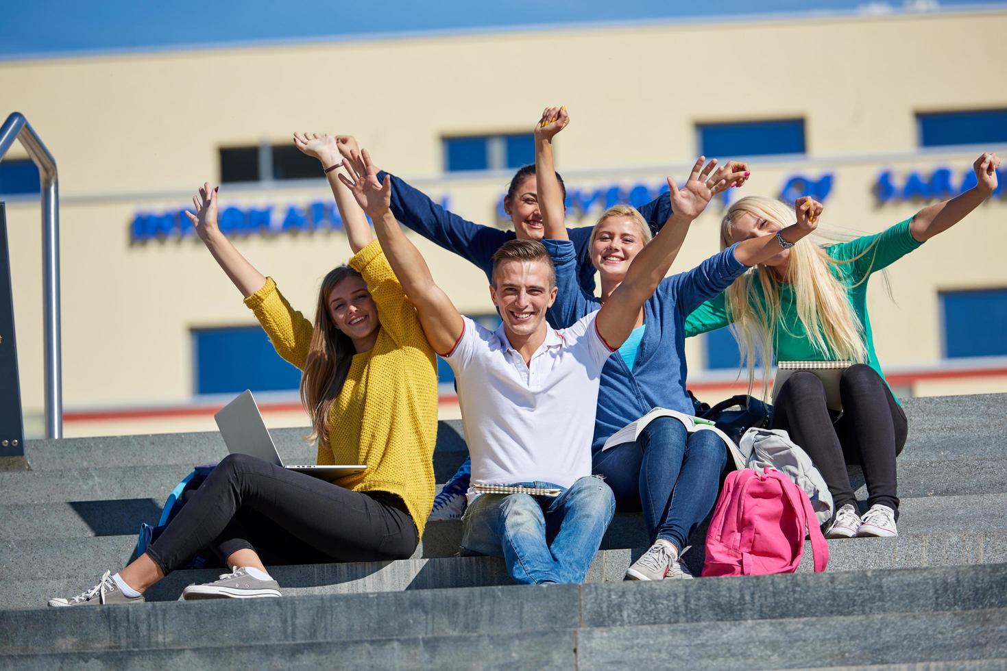 studenti al di fuori seduta su passaggi foto