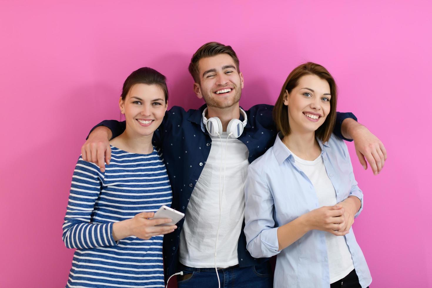 gruppo di amici avere divertimento e danza mentre utilizzando un' cellula Telefono e cuffie foto