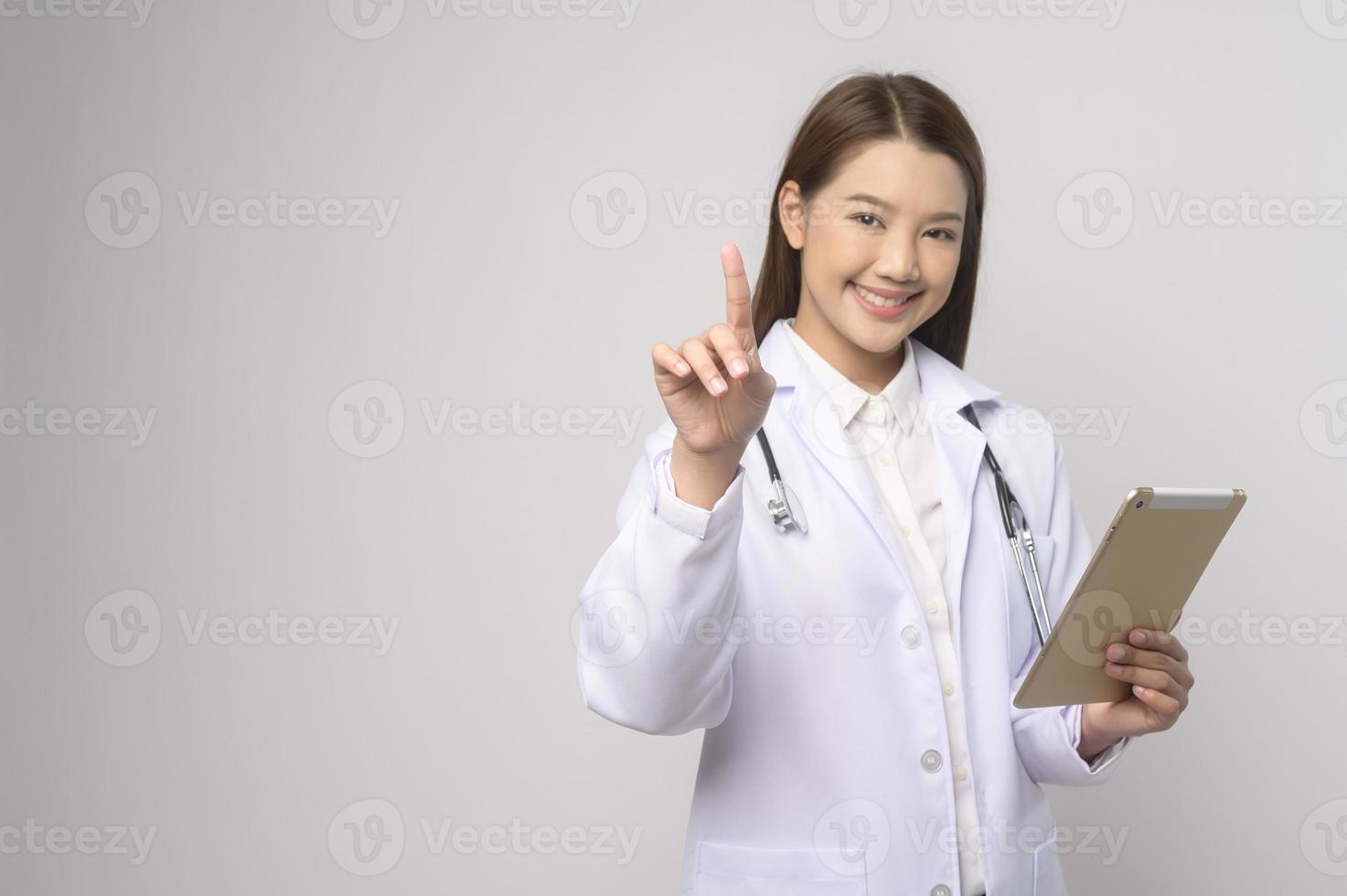 ritratto di femmina fiducioso medico al di sopra di bianca sfondo studio, assistenza sanitaria e medico tecnologia concetto. foto