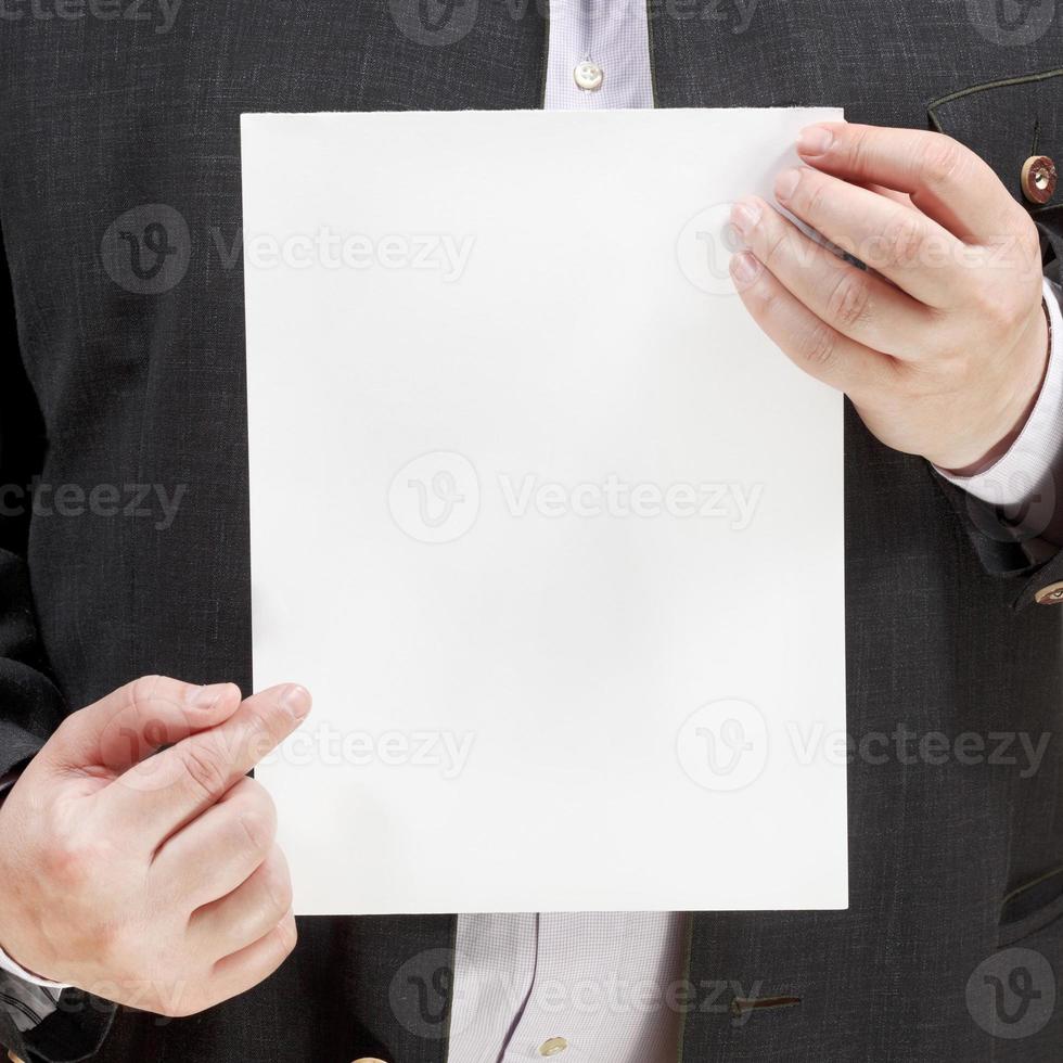 venditore detiene vuoto foglio di carta nel mani foto
