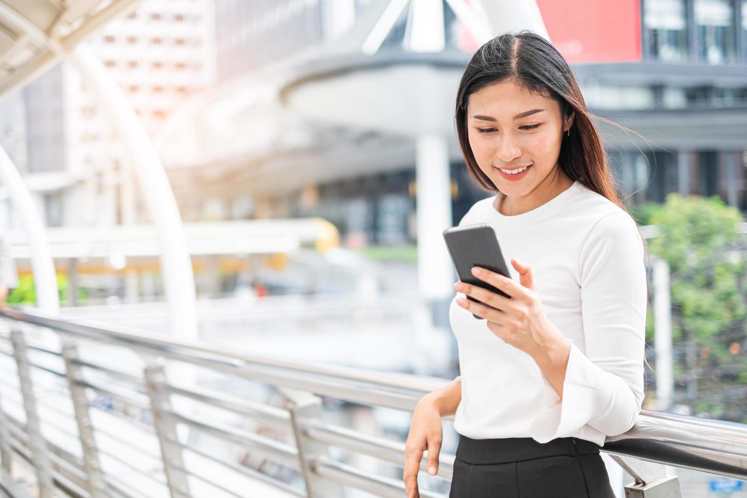 Ritratto di donna asiatica che tiene smartphone foto