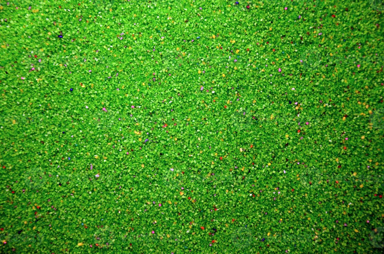 struttura di un' colorato granulare sabbia vicino su. verde cereali foto