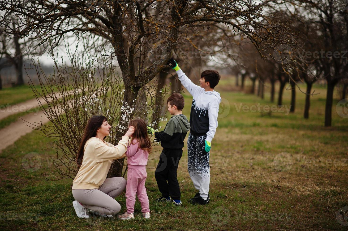 madre con bambini Lavorando nel primavera giardino. foto