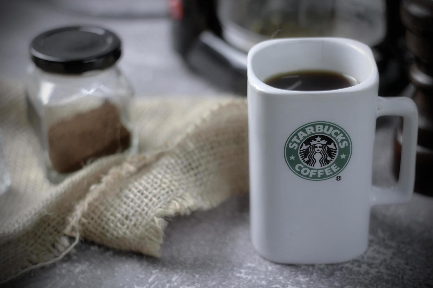 Washington - Stati Uniti d'America settembre, 26 2022 Starbucks caffè boccale su grigio tavolo con caffè bottiglia e caffè macinino. foto