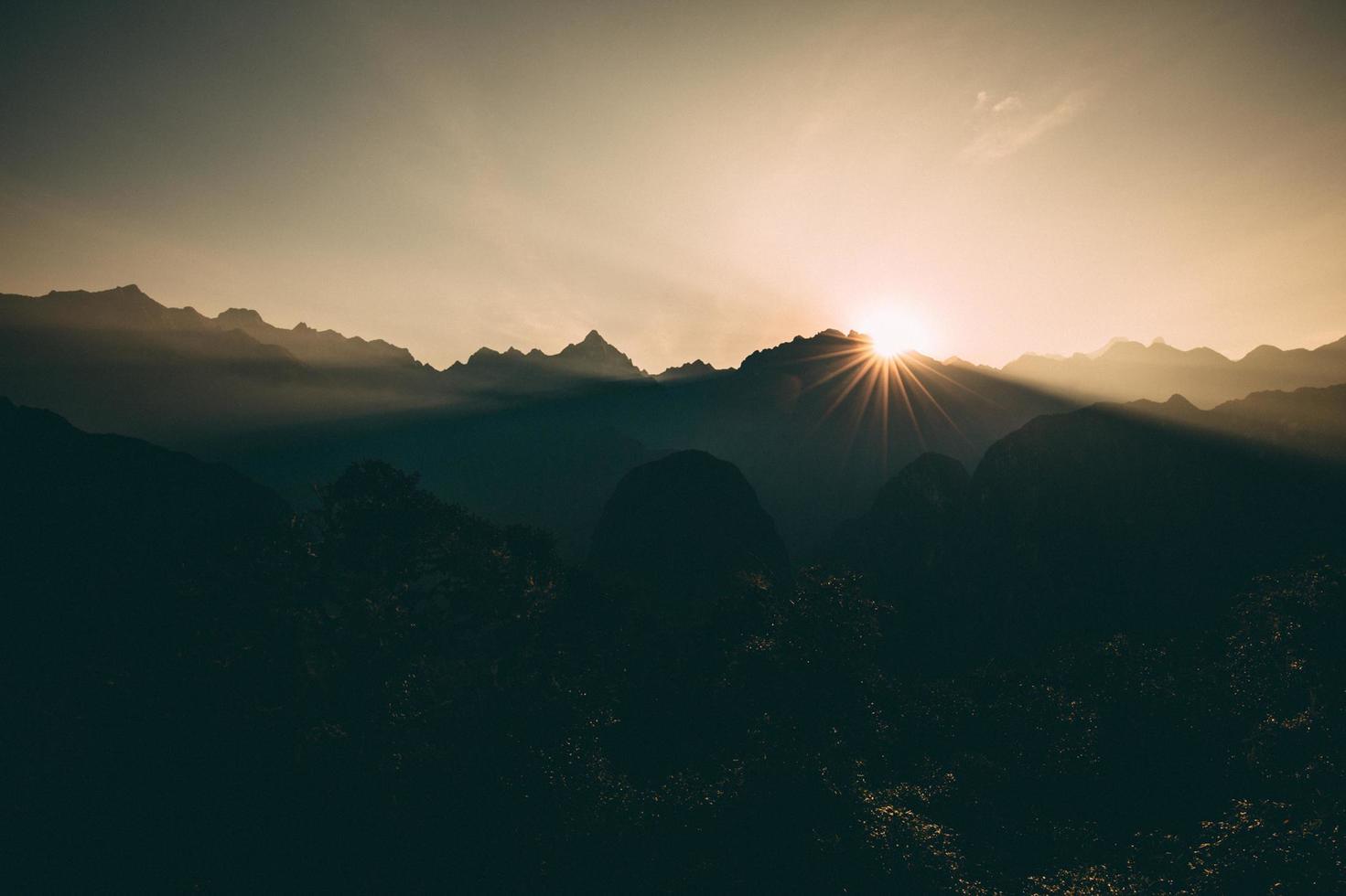 sagoma di montagne durante il tramonto foto