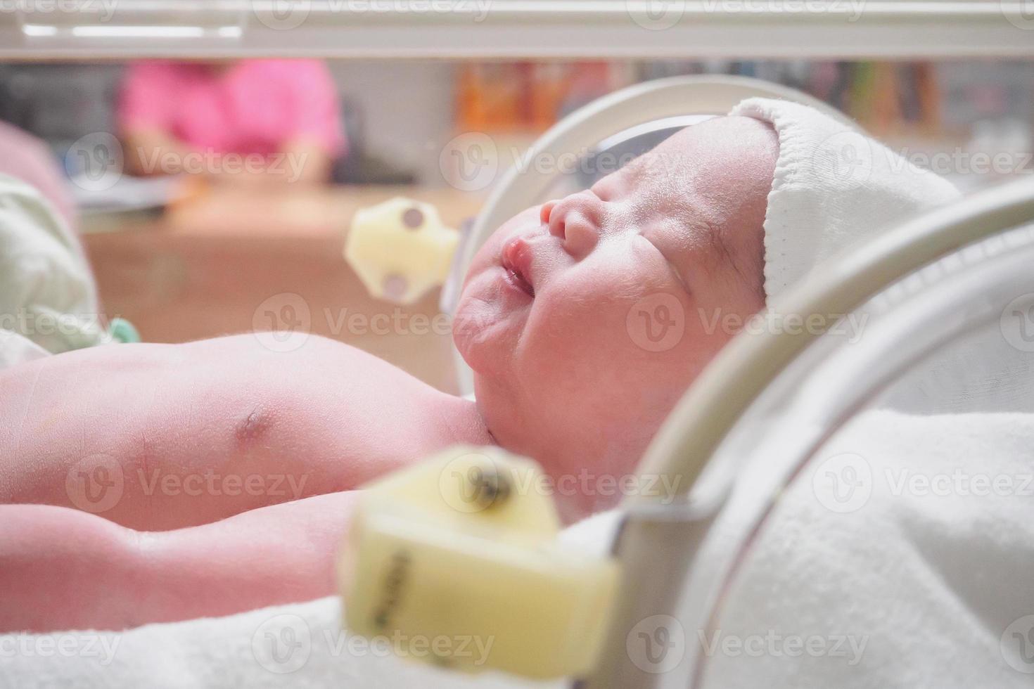 nuovo Nato bambino infantile dormire nel il incubatrice a ospedale foto