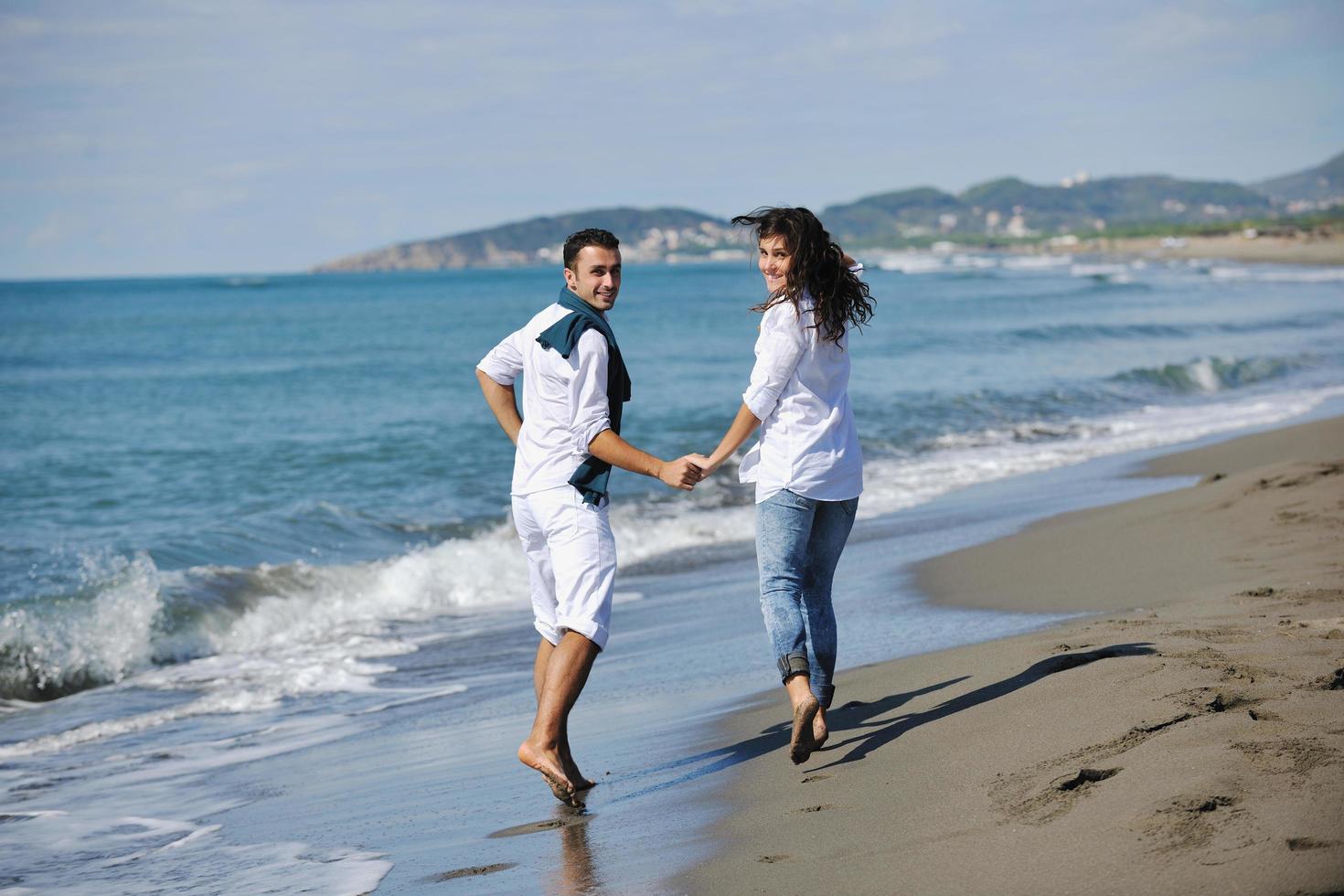 contento giovane coppia avere divertimento a bellissimo spiaggia foto